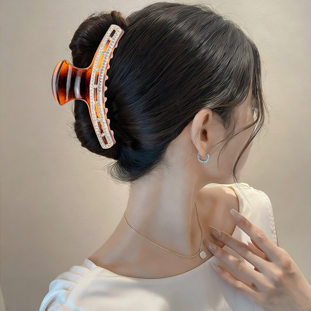 Tortoise rhinestone claw clip styled in low bun