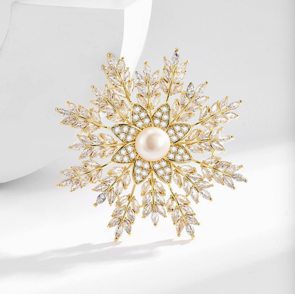 Model wearing snowflake pearl brooch on black blazer