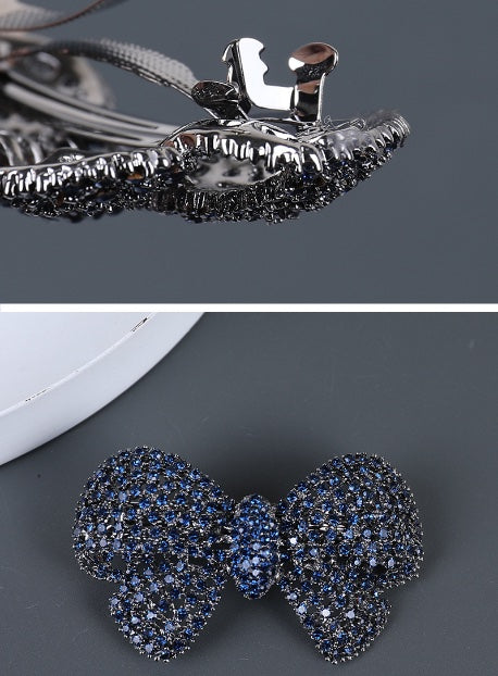 Blue and gray rhinestone bow hair clips with size and weight details
