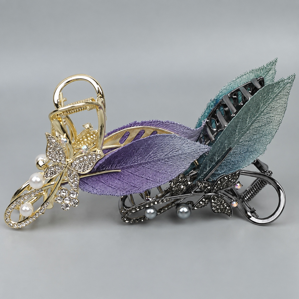 Purple gold-tone and teal-gray gunmetal-tone leaf hair claw clips, shown together for comparison; each sold separately. AI-assisted supplier photo edit.