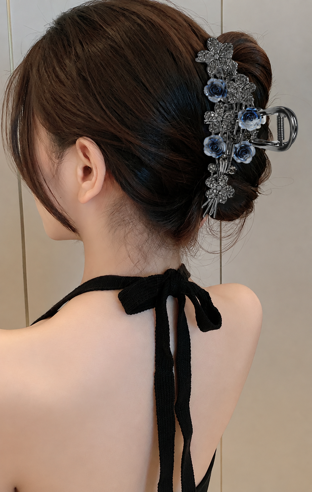 Statement A382 blue-gray rose and gunmetal-tone floral hair claw worn in an updo. AI-assisted supplier styling image.