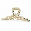Gold-tone floral hair claw with ivory-colored petals, rhinestones and an imitation pearl accent. AI-assisted supplier photo edit.