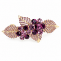 Purple A841 floral leaf barrette with plum and mauve faceted stones, four rhinestone-trimmed leaves and a gold-tone frame. AI-assisted supplier photo edit.