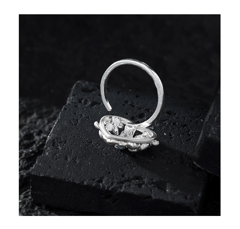 Back view showing the ring's open adjustable band and floral setting