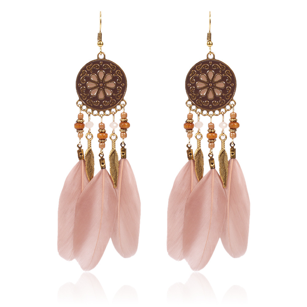 Pair of blush pink feather earrings with floral medallions
