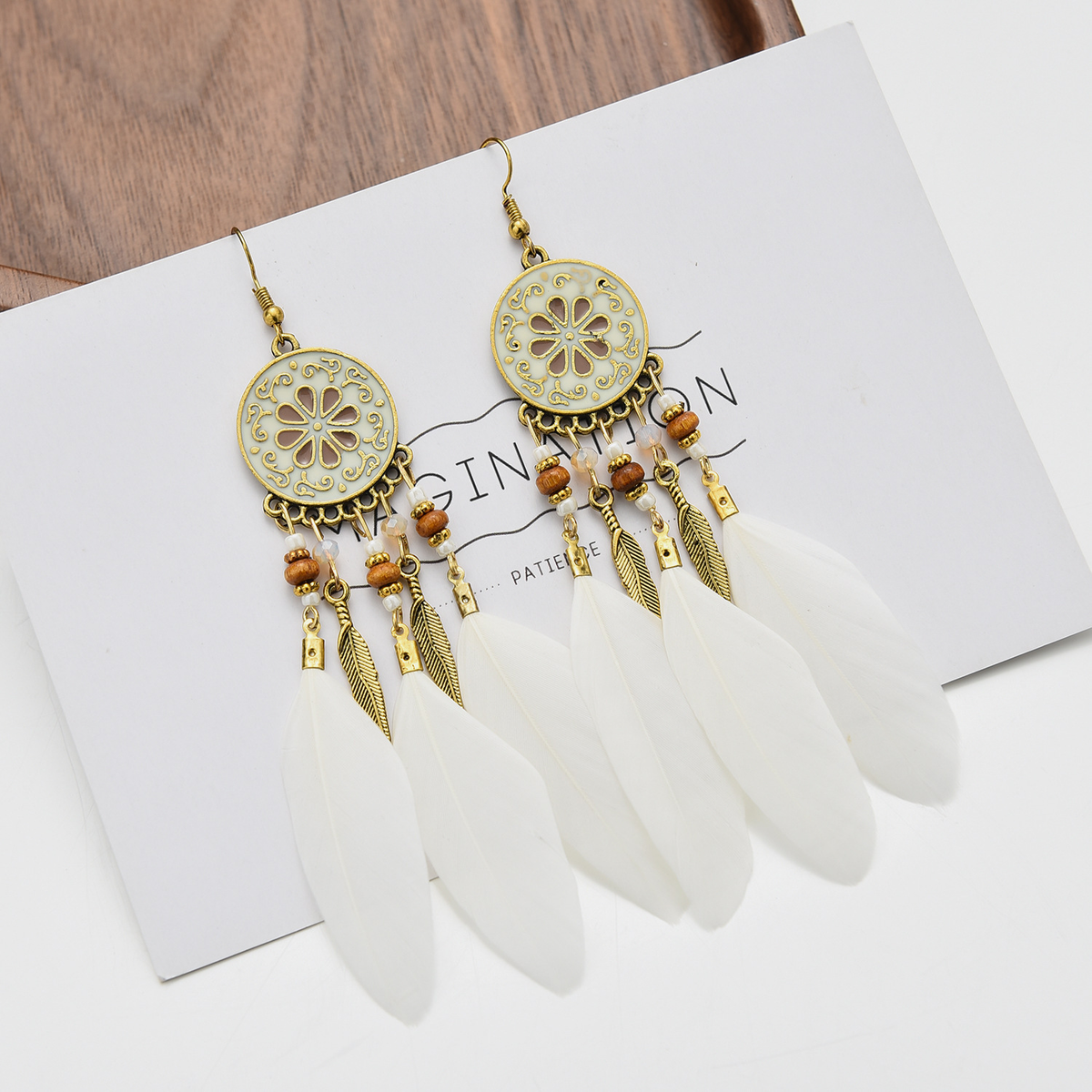 Pair of white floral medallion feather earrings