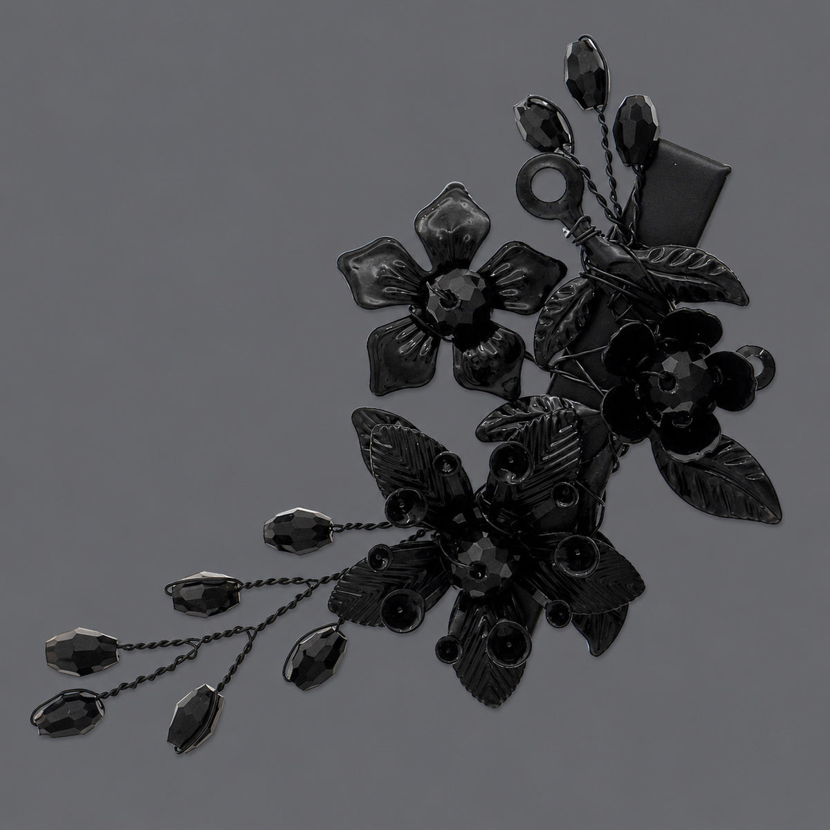 Black Rhinestone Floral Spray Hair Clip on a gray background