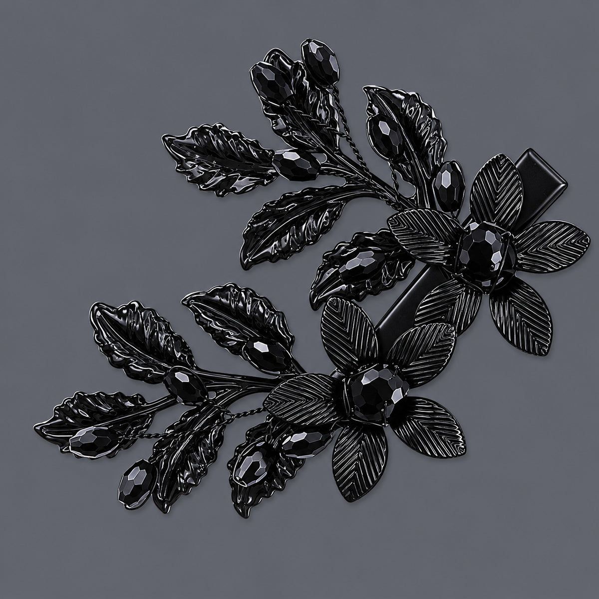 Black Flower & Leaf Hair Clips - Set of 2 on a gray background