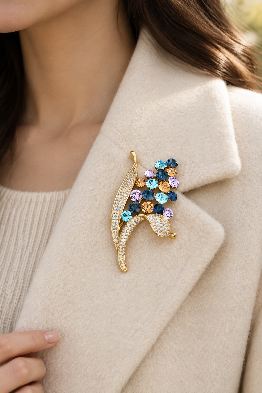 Multicolor floral bouquet brooch pinned on a cream coat lapel