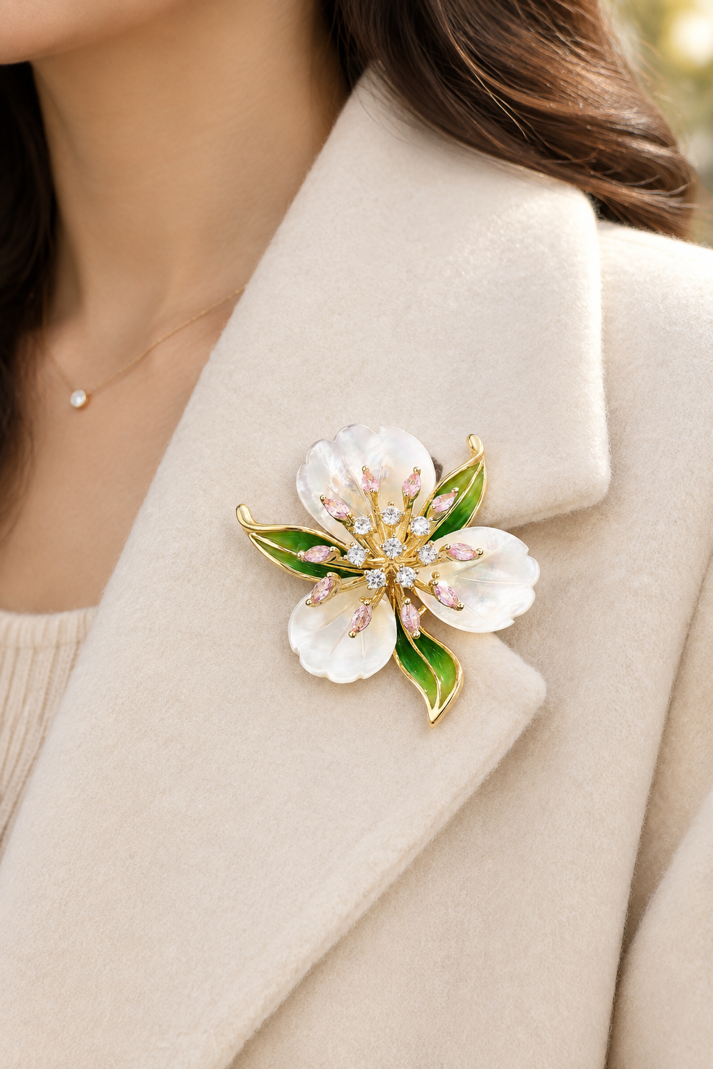 Pearlescent flower brooch pinned on a cream coat lapel