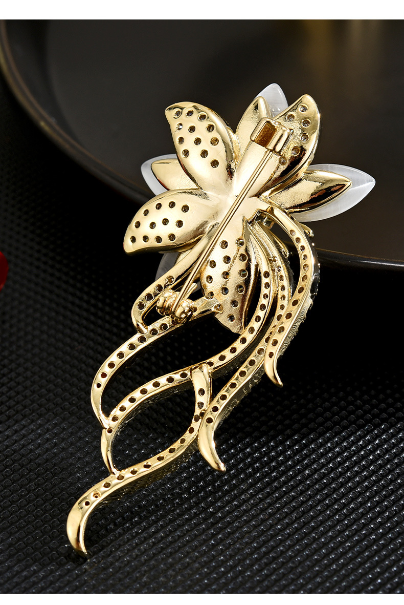 Back of the gold-tone orchid brooch showing its pin-back closure