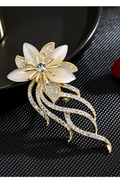 Gold-tone orchid brooch with imitation cat-eye petals and clear rhinestone trailing stems