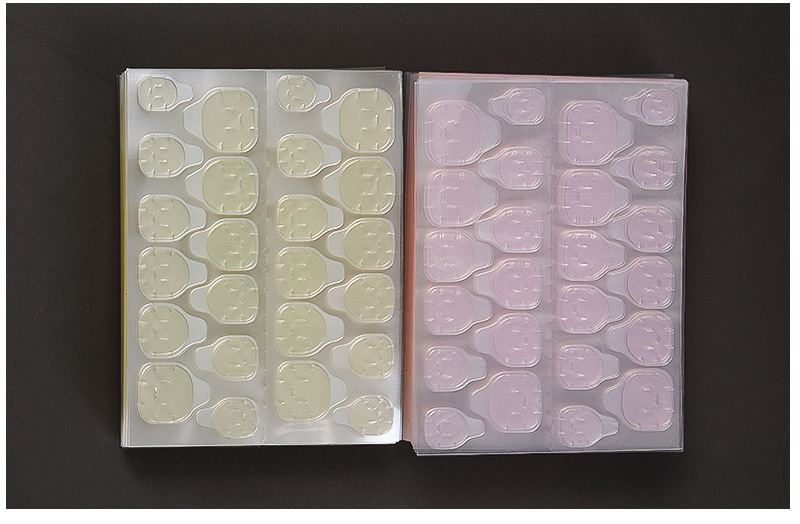 Press-on nail jelly adhesive tab sheets in clear and yellow finishes, two sheets side by side