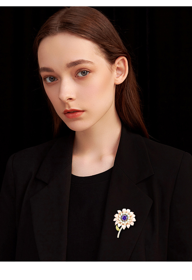 Pastel enamel flower brooch with a purple center styled on a black blazer