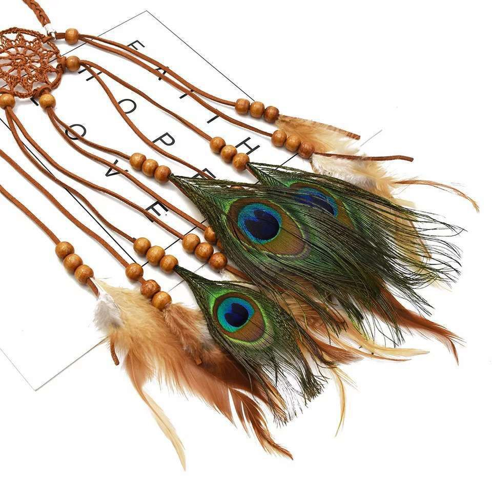 Flat-lay detail of the brown woven-circle centerpiece, cords, beads, and long feather tassels