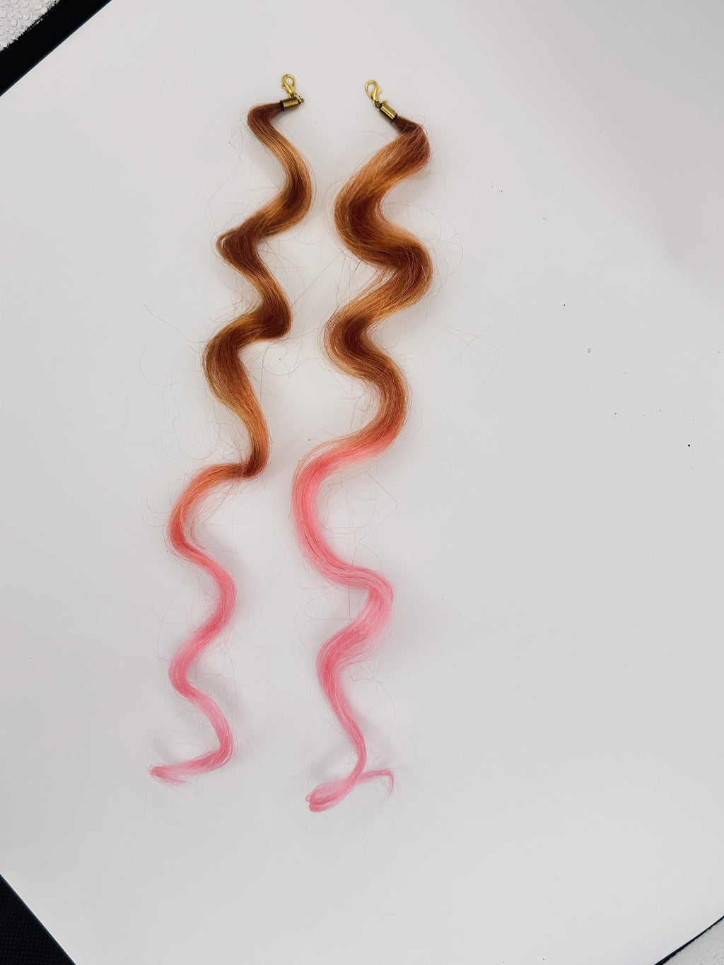Brown-to-pink ombre wavy synthetic hair charm pair with gold-tone clasps; product photograph.