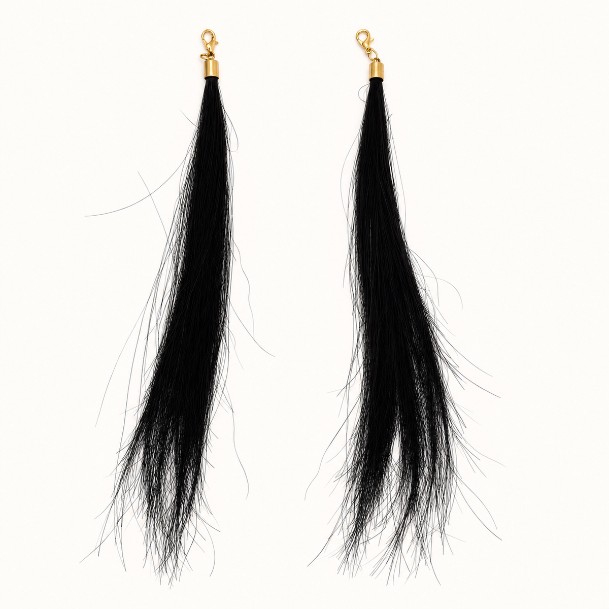 Pair of Black human hair charms with gold-tone lobster clasps, approximately 18 cm hair length.
