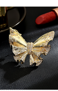 Gold-tone butterfly brooch with textured wings and clear cubic zirconia accents, front view