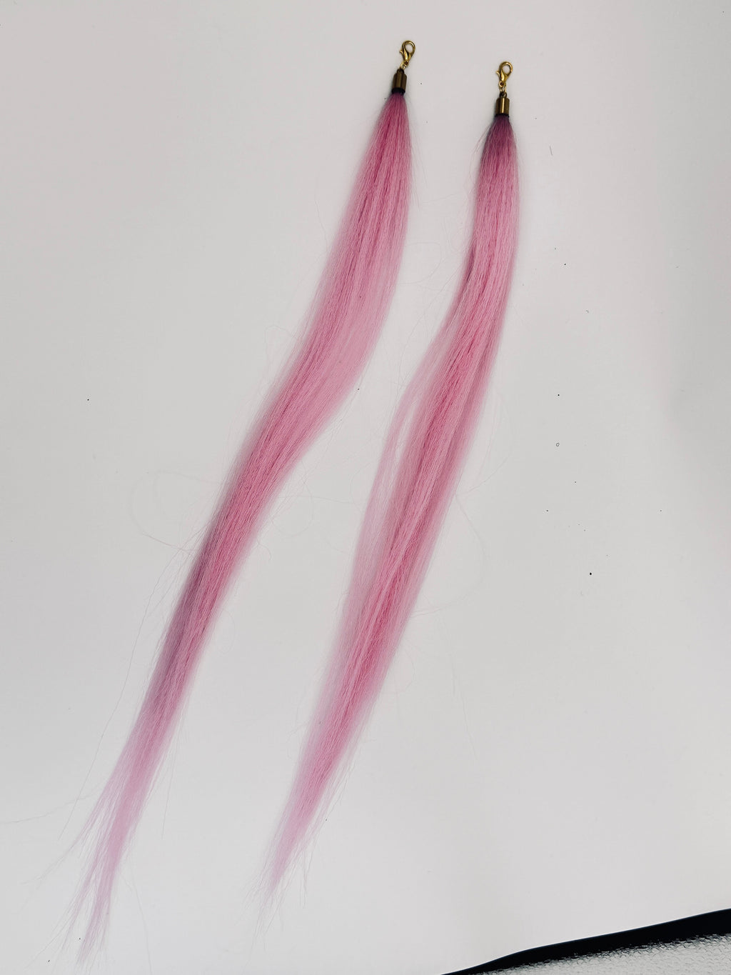 Pink straight synthetic hair charm pair with gold-tone clasps; product photograph.