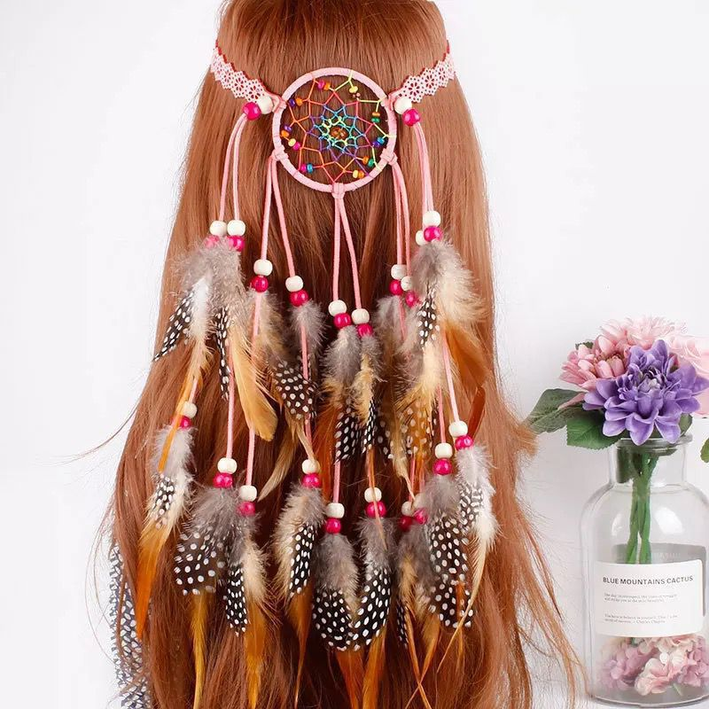 Pink woven-circle feather headband displayed on a mannequin with pink cords and feather tassels