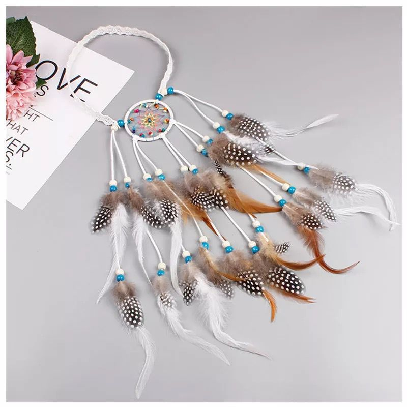 White woven-circle feather headband laid flat to show the band and long feather tassels