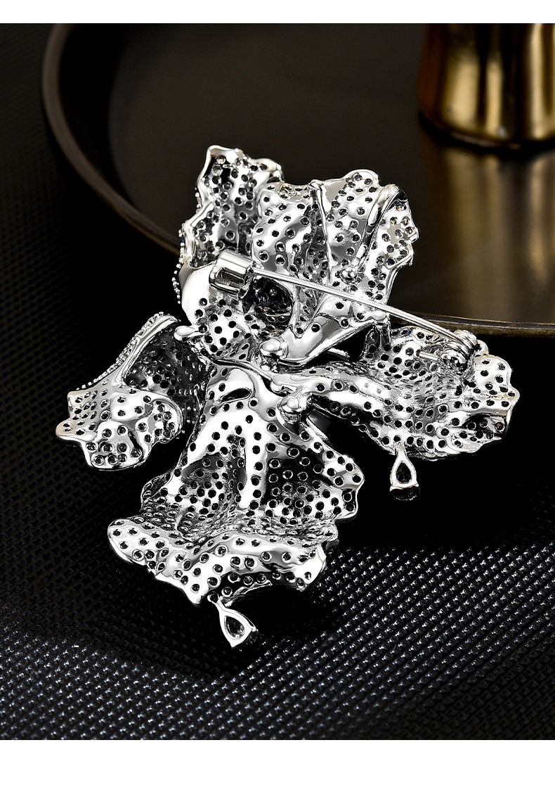 Back of the silver-tone iris flower brooch showing the pin fastening and clasp