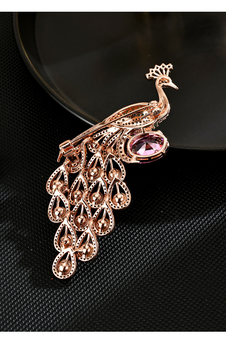 Back of the rose-gold-tone peacock brooch showing its pin and clasp