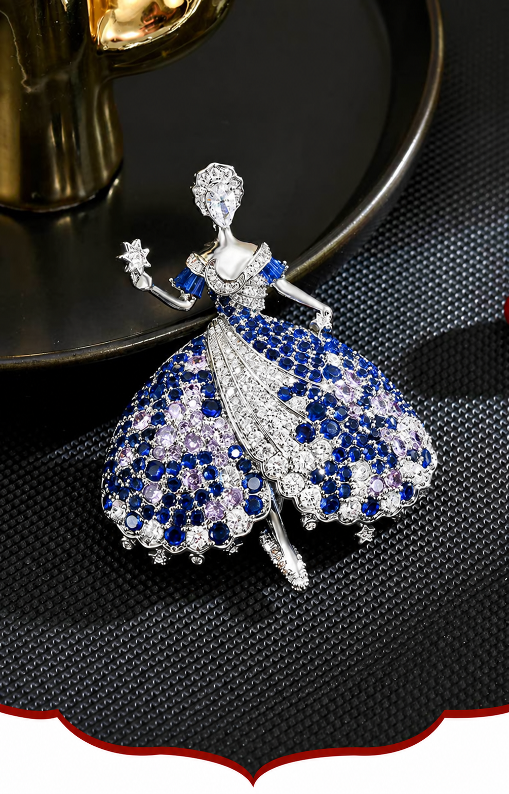 Silver-tone ballerina brooch with blue, lavender and clear cubic zirconia, a handheld star and dangling skirt accents