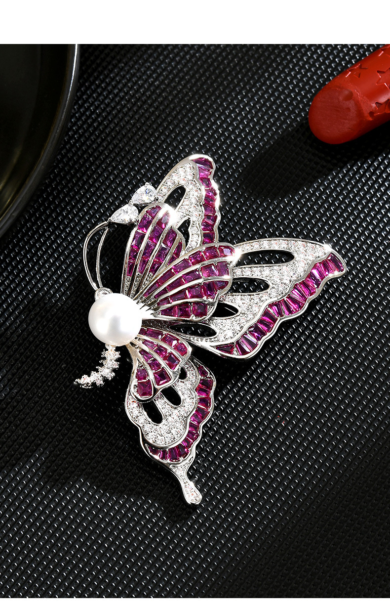 Silver-tone butterfly brooch with purple cubic zirconia, clear accents and a white freshwater pearl