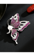 Silver-tone butterfly brooch with purple cubic zirconia, clear accents and a white freshwater pearl