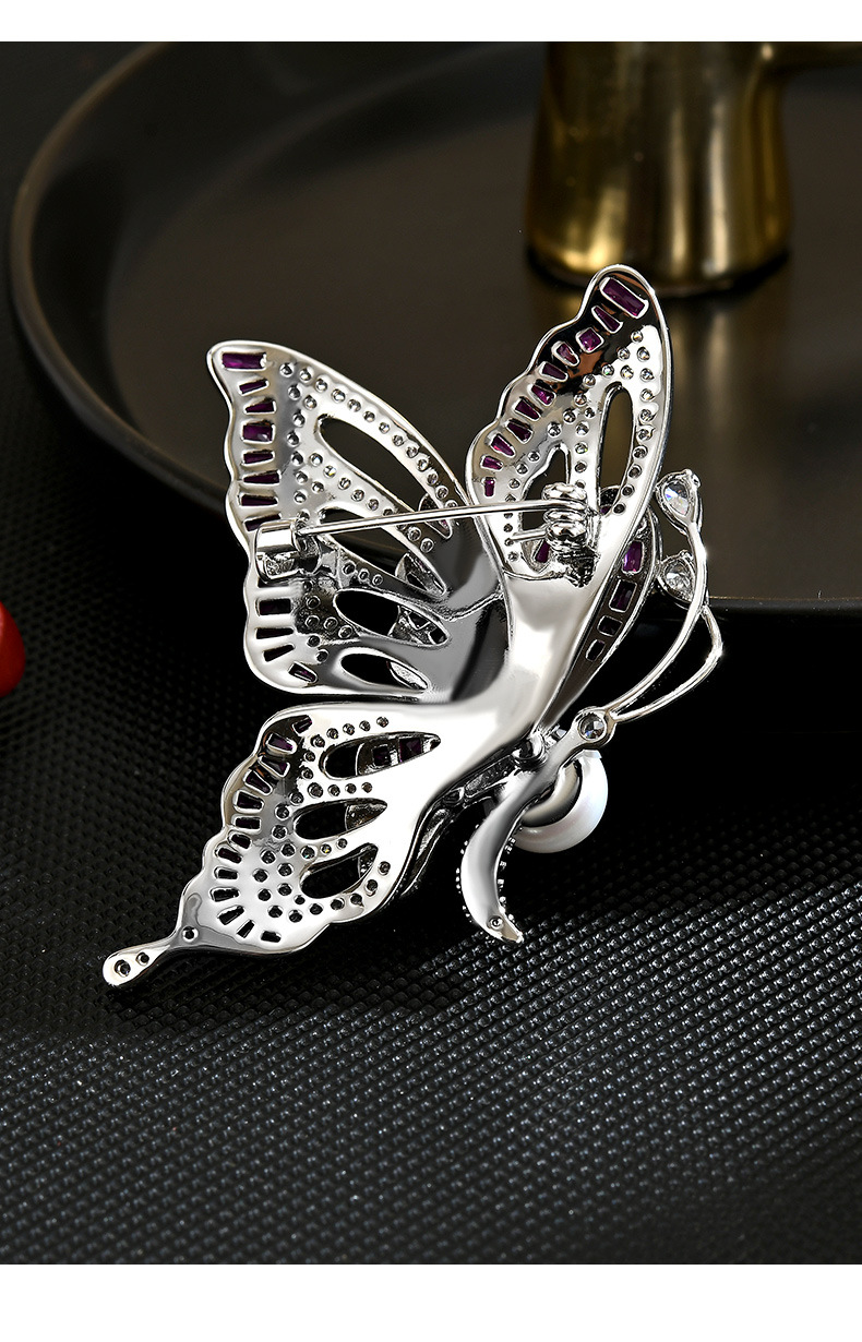 Back of the silver-tone butterfly brooch showing its pin fastening and clasp