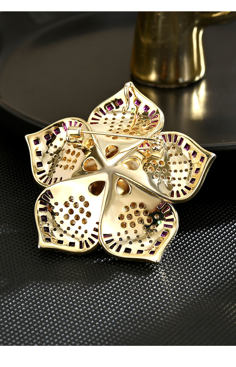 Back of the gold-tone camellia brooch showing its pin and clasp