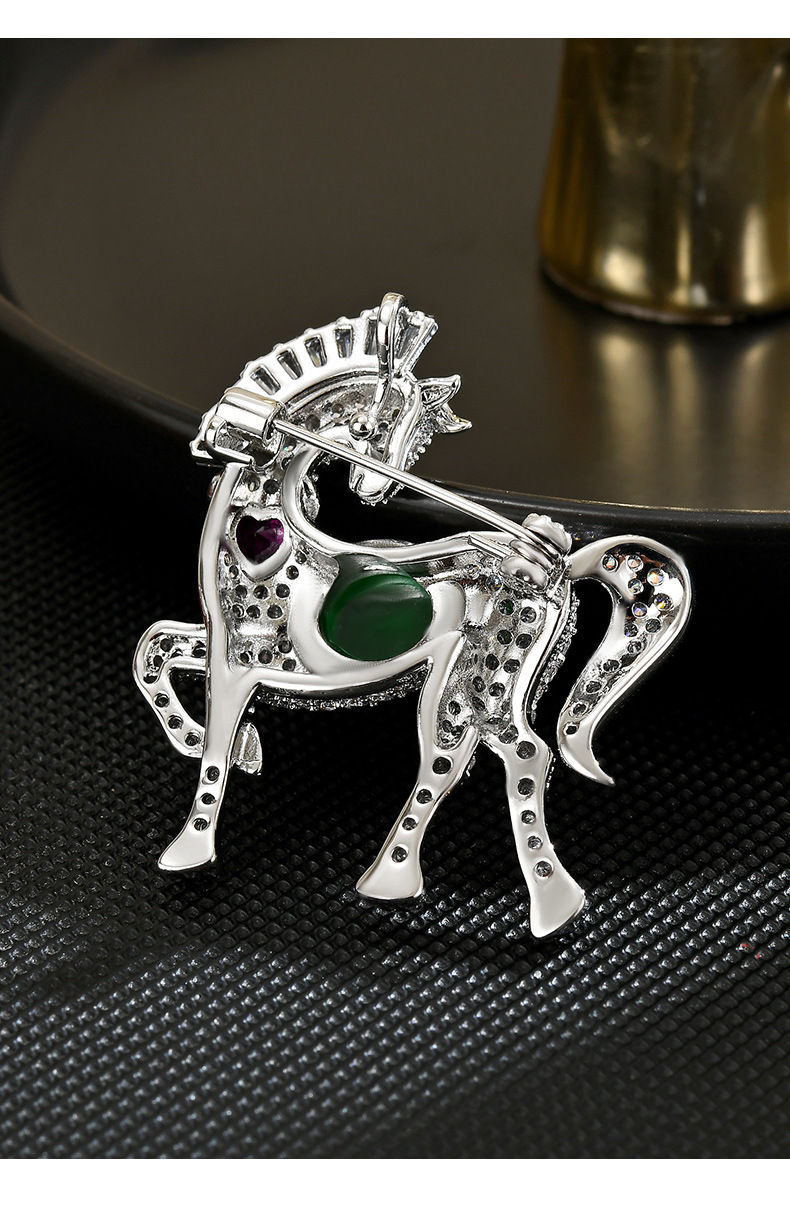 Back of the silver-tone horse brooch showing its pin and clasp