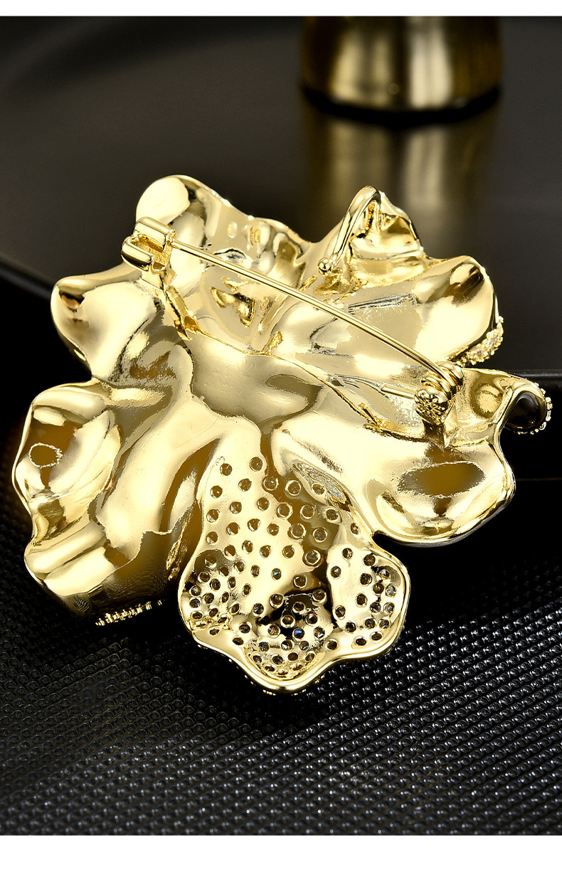 Back of the gold-tone peony brooch showing the pin fastening and sculpted flower construction
