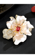 Pearlescent cream peony brooch with a red rectangular center stone, pink accents and sparkling gold-tone details