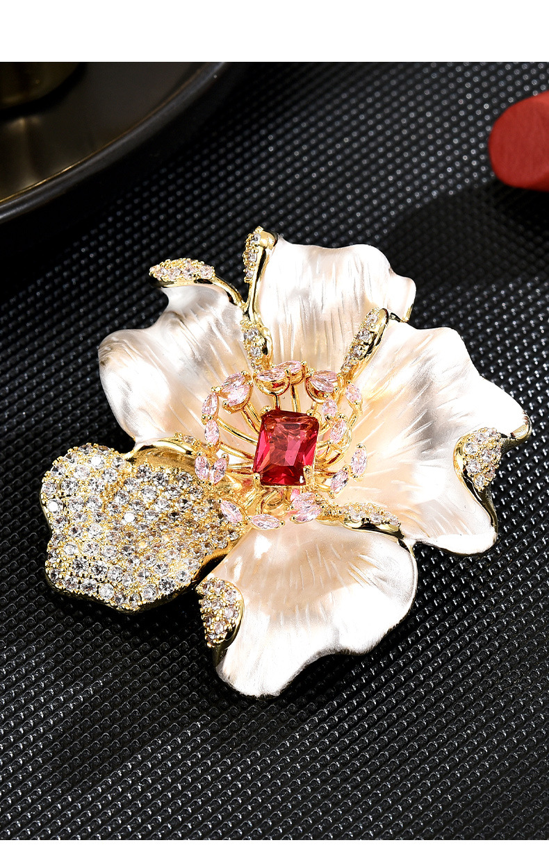 Pearlescent cream peony brooch with a red rectangular center stone, pink accents and sparkling gold-tone details