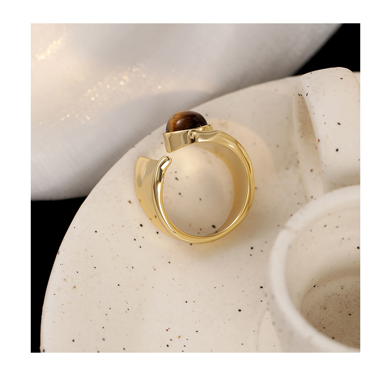 Back and side view showing the sculptural ring's open adjustable band