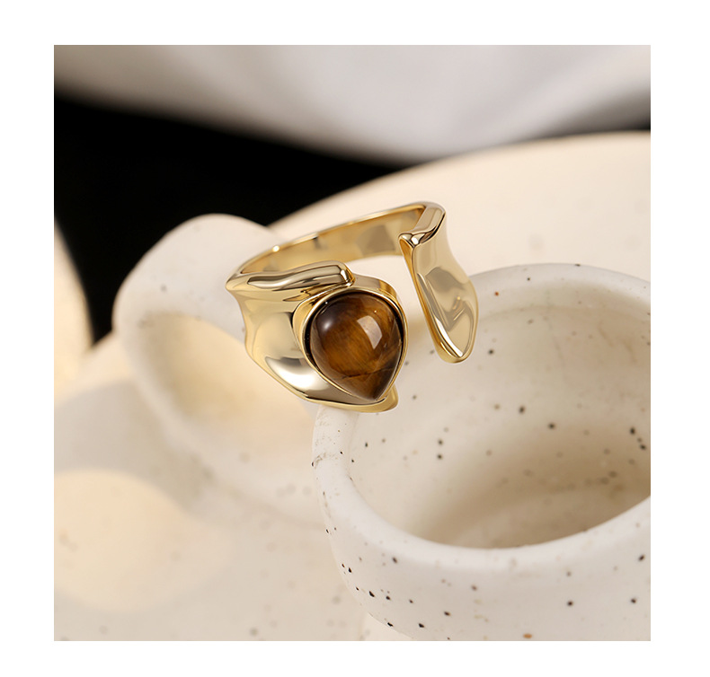 Sculptural gold-tone open ring with a brown teardrop tiger's eye centerpiece